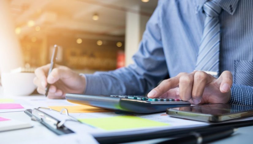 Business finance man calculating budget numbers, Invoices and fi